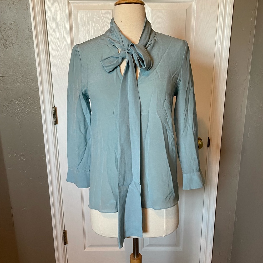 Alice & Olivia light blue silk top with tie.